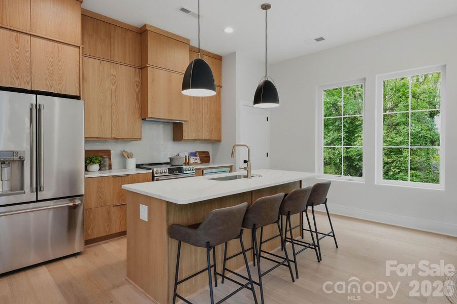 Custom white oak cabinetry with GE Cafe Series appliances