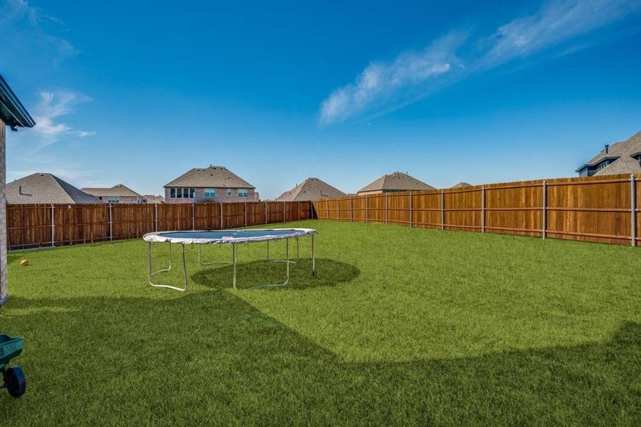 View of yard with a trampoline