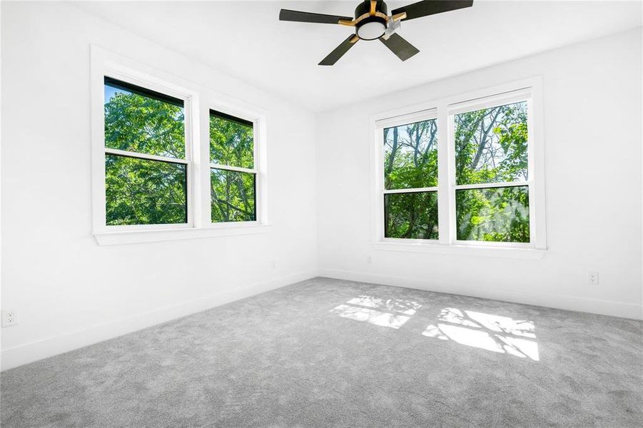 Unfurnished room with ceiling fan and carpet flooring