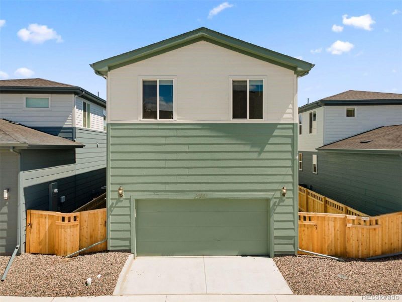 Front exterior of a new home in Woodrose at Painted Prairie, Aurora, CO, highlighting curb appeal (Image 20).