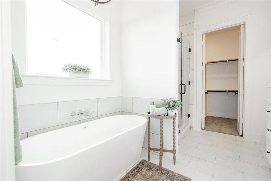 Bathroom with tile patterned flooring and separate shower and tub