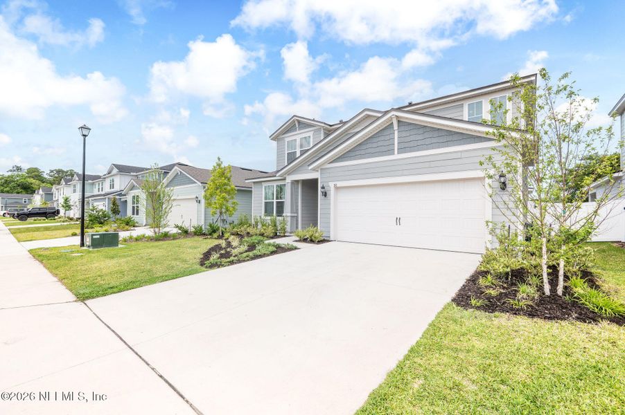 Front exterior of a new home in Rolling Hills, St. Augustine, FL, highlighting curb appeal (Image 22).