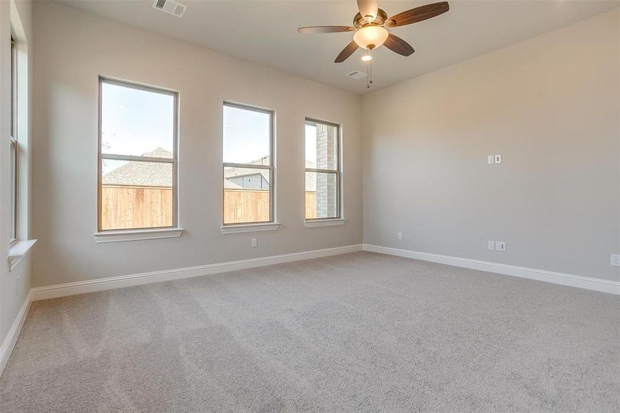 Spare room featuring carpet flooring and ceiling fan