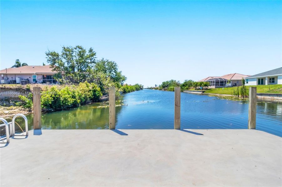 Dock area featuring a water view straight down fresh water canal