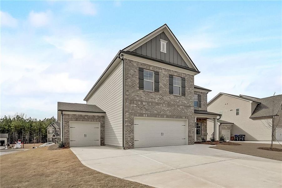 Front exterior of a new home in Summerlin, Winder, GA, highlighting curb appeal (Image 1).
