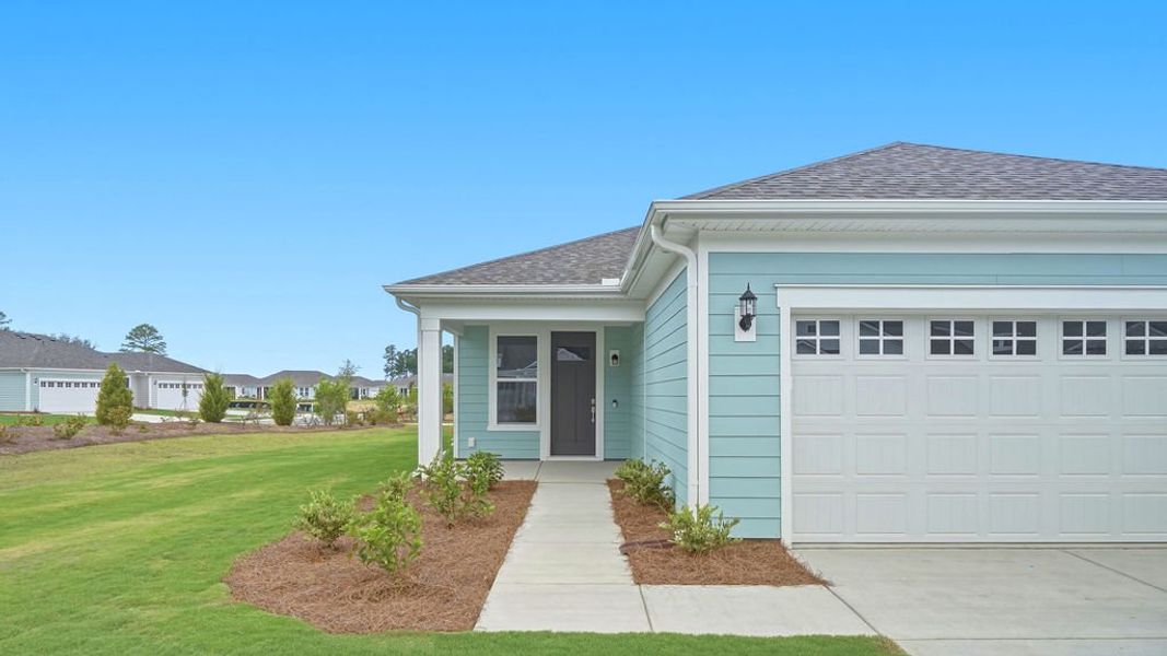 Front exterior of a new home in Sun City Hilton Head, Bluffton, SC, highlighting curb appeal (Image 22). Front exterior of a new home in Sun City Hilton Head, Bluffton, SC, highlighting curb appeal (Image 22).