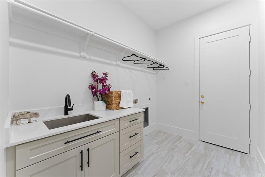 Laundry room featuring cabinet space, washer hookup, and electric dryer hookup