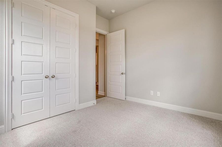 Unfurnished bedroom featuring a closet and carpet floors