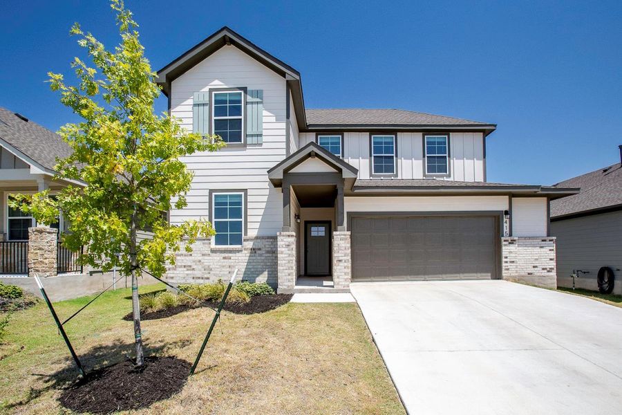 Front exterior of a new home in Brooks Ranch, Kyle, TX, highlighting curb appeal (Image 26).