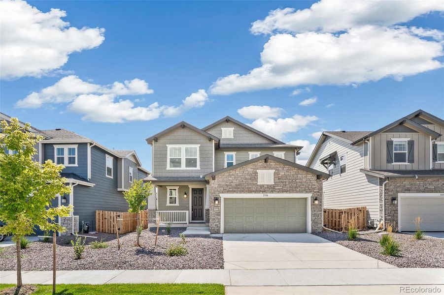 Front exterior of a new home in Turnberry, Commerce City, CO, highlighting curb appeal (Image 2).