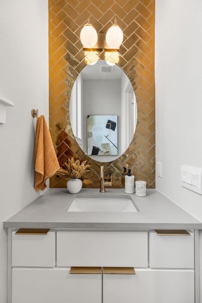 Bathroom featuring visible vents and vanity