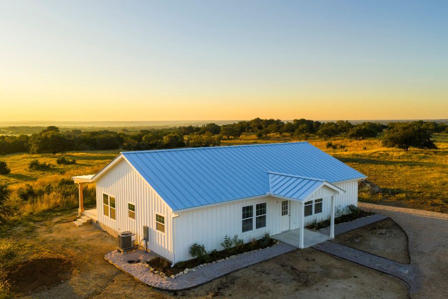 View of front of home with a standing seam roof, board and batten siding, and a porch