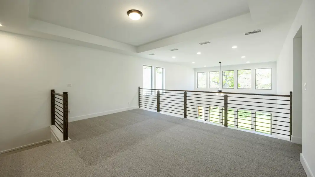 Carpeted empty room featuring baseboards, visible vents, and recessed lighting Carpeted empty room featuring baseboards, visible vents, and recessed lighting