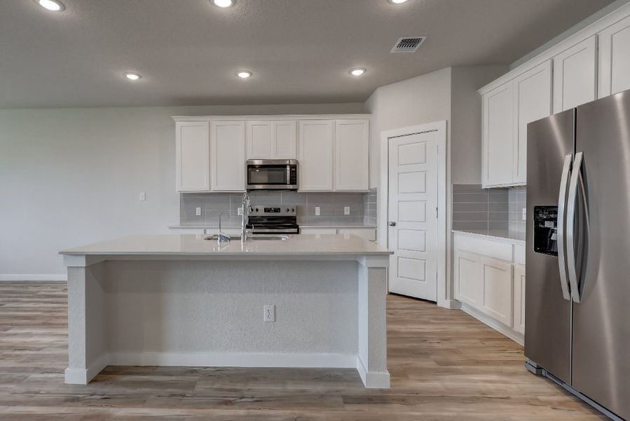 A kitchen with white cabinets. A kitchen with white cabinets.