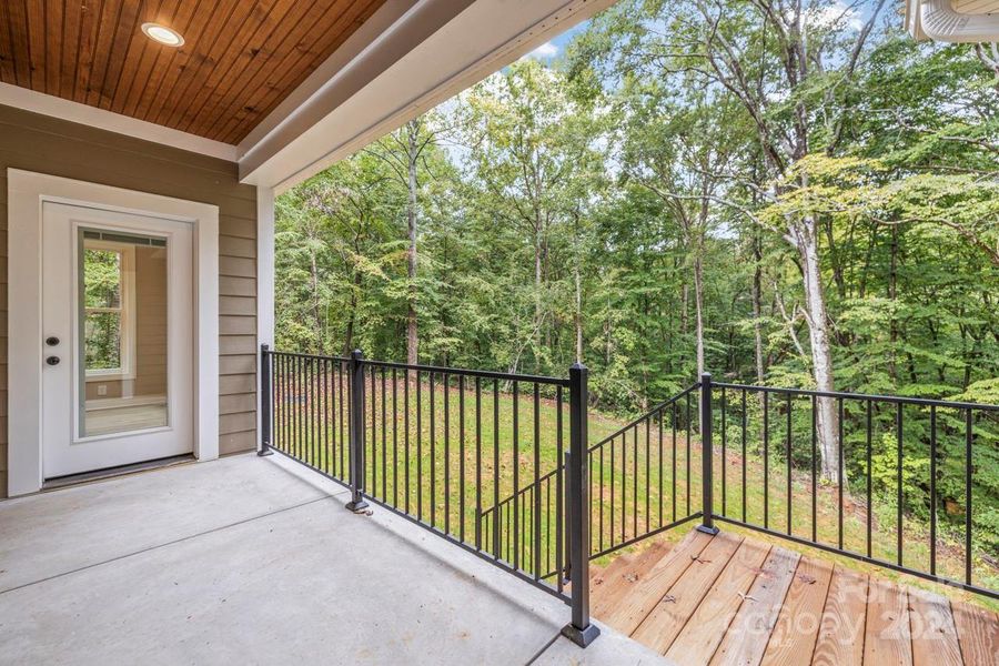 Relax on the covered rear porch and enjoy the sights and sounds of nature