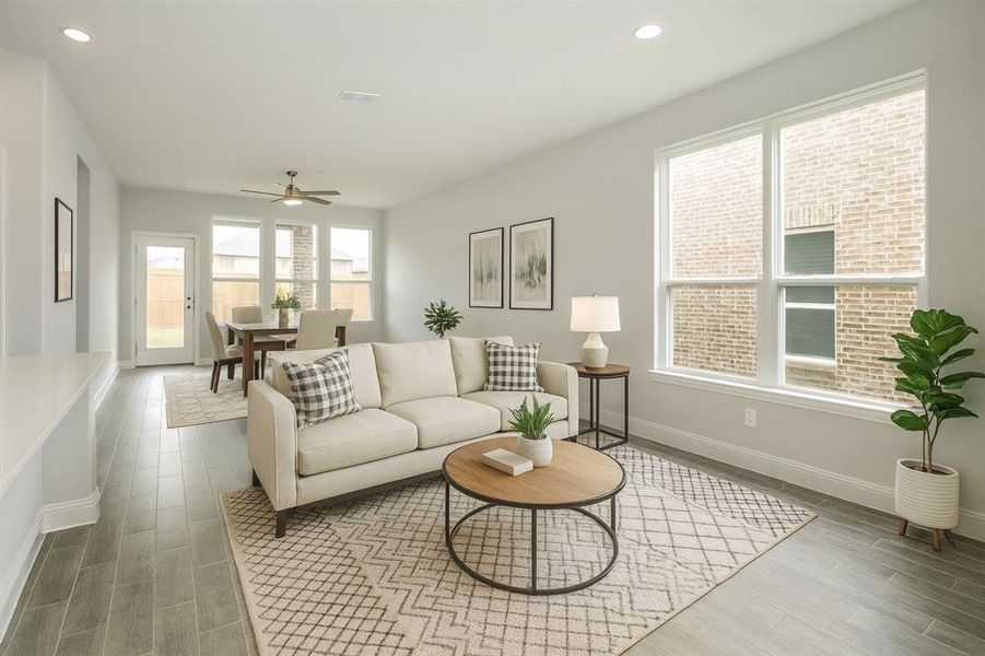 Living area with recessed lighting, wood finish floors, healthy amount of natural light, and ceiling fan Living area with recessed lighting, wood finish floors, healthy amount of natural light, and ceiling fan