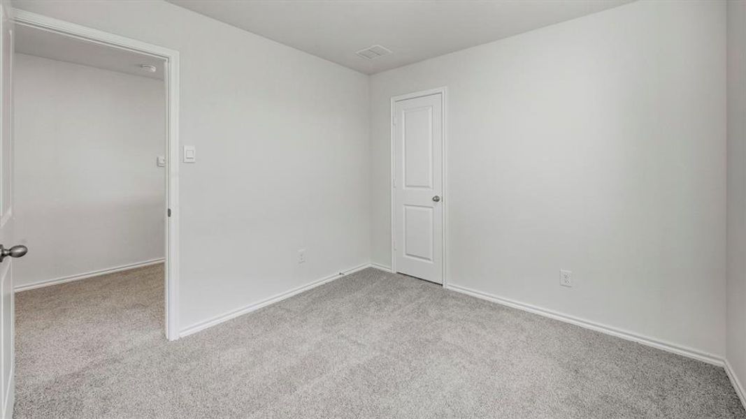 Unfurnished room with light carpet and baseboards