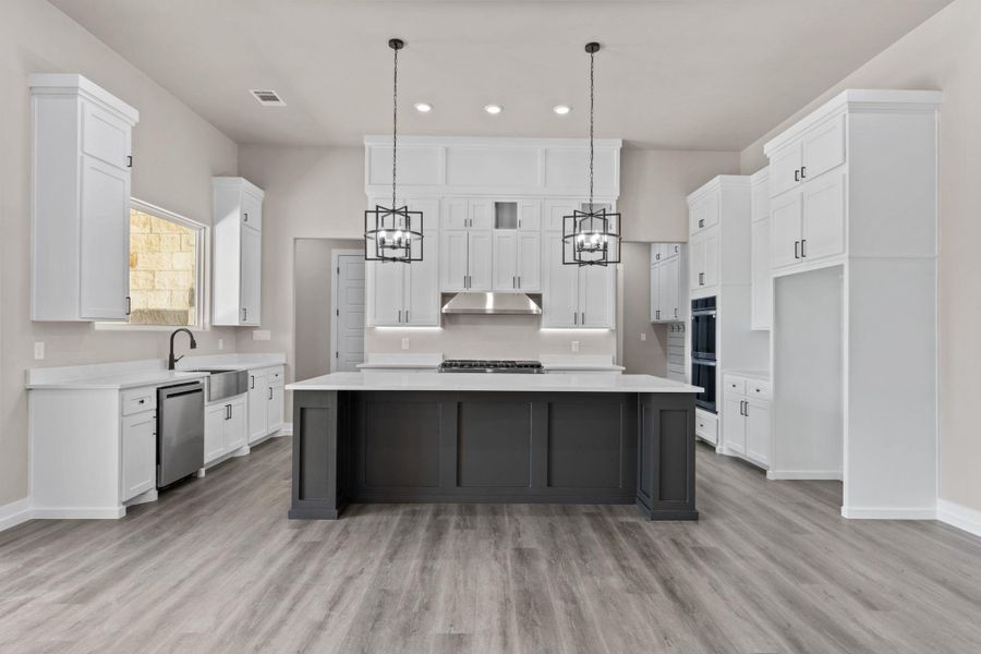 A spacious, newly appointed culinary haven awaits, complete with a central island and contemporary fixtures. A spacious, newly appointed culinary haven awaits, complete with a central island and contemporary fixtures.