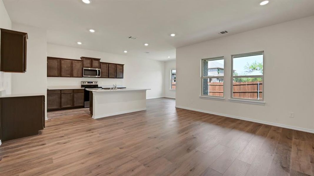 Open concept living space featuring wood-finish flooring