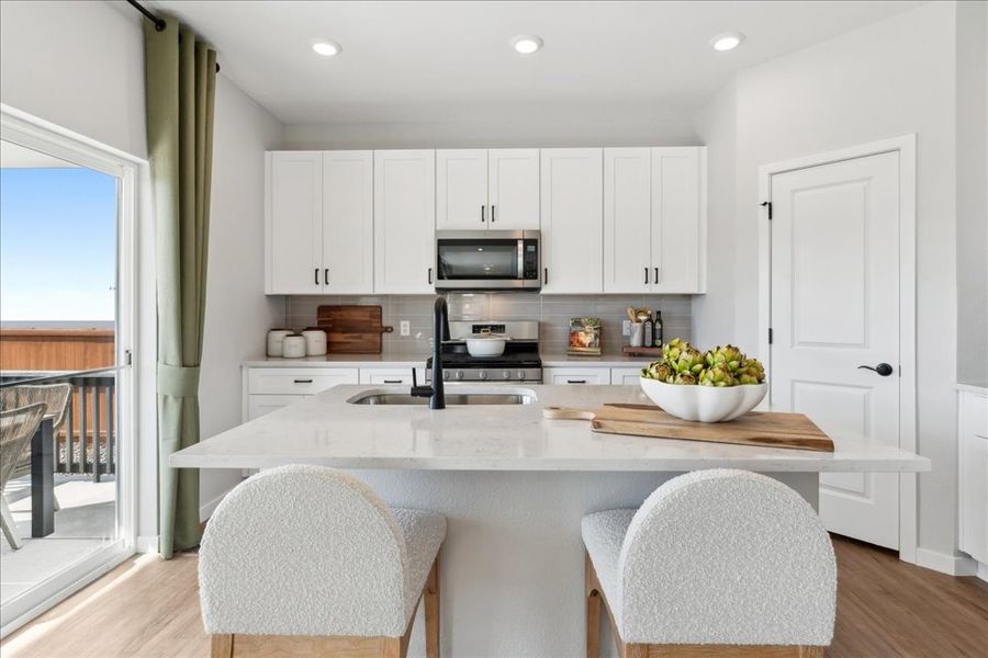 A kitchen with white cabinets. A kitchen with white cabinets.