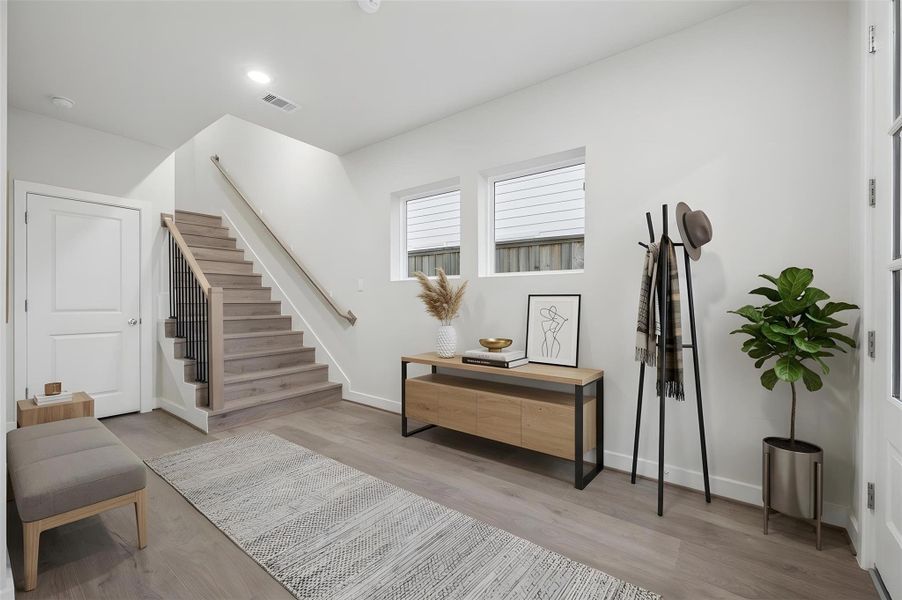 large inviting foyer, Swiss engineered flooring throughout the home.