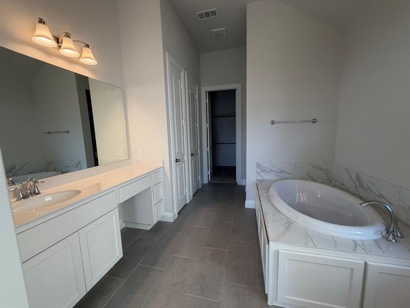 Full bathroom with a bath and vanity