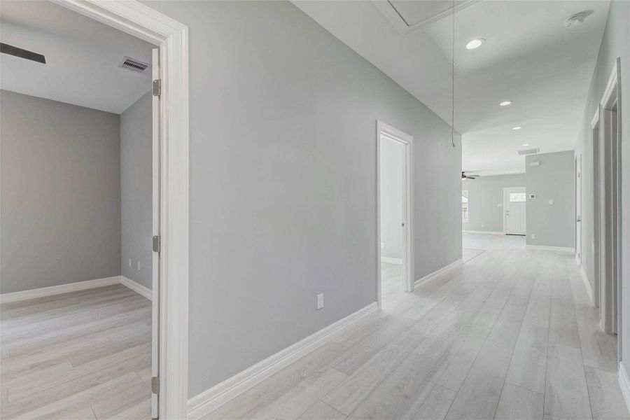 Wide hallway designed to accommodate easy movement, including for those needing additional mobility space.