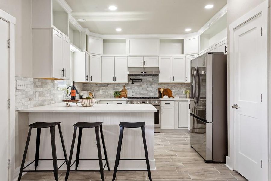 Culinary delights await in this bright kitchen with modern appliances and a functional island. Culinary delights await in this bright kitchen with modern appliances and a functional island.