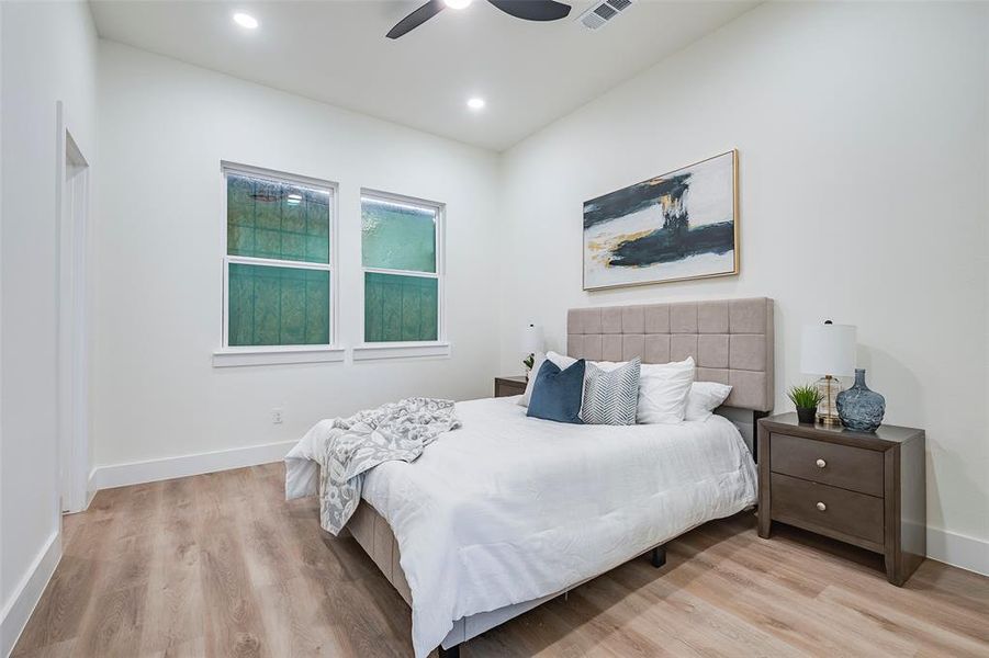 Bedroom featuring ceiling fan and light hardwood / wood-style floors