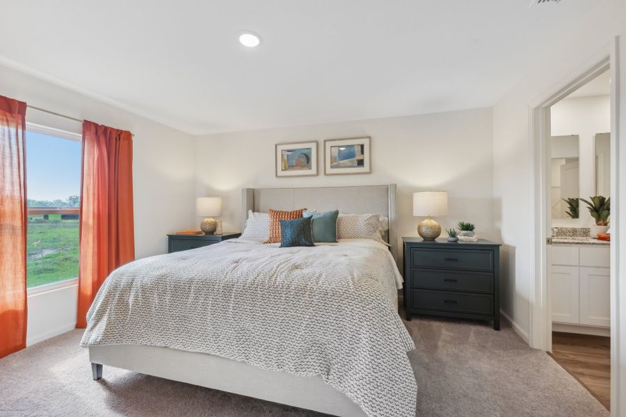 A bedroom with a large window.