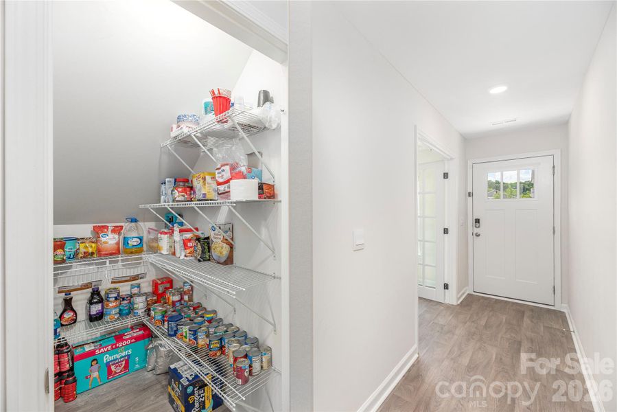 Under the stairwell extra storage with shelving.