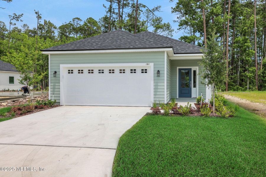 Front exterior of a new home in TrailMark, St. Augustine, FL, highlighting curb appeal (Image 18). Front exterior of a new home in TrailMark, St. Augustine, FL, highlighting curb appeal (Image 18).