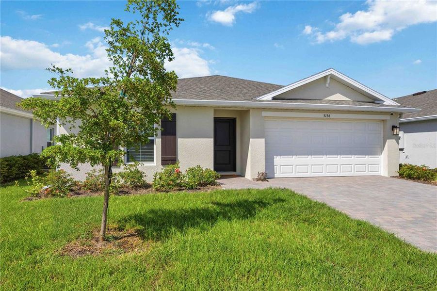 Front exterior of a new home in Central Parc, North Port, FL, highlighting curb appeal (Image 22).