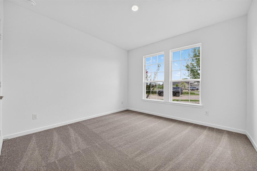 This bright bedroom features plush carpeting and large windows that bring in plenty of natural light, creating a cozy and inviting retreat. This bright bedroom features plush carpeting and large windows that bring in plenty of natural light, creating a cozy and inviting retreat.