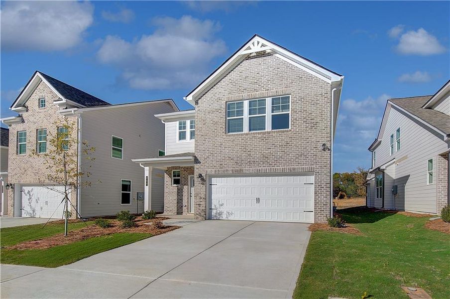 Front exterior of a new home in Abbotts Crossing, Conyers, GA, highlighting curb appeal (Image 14).