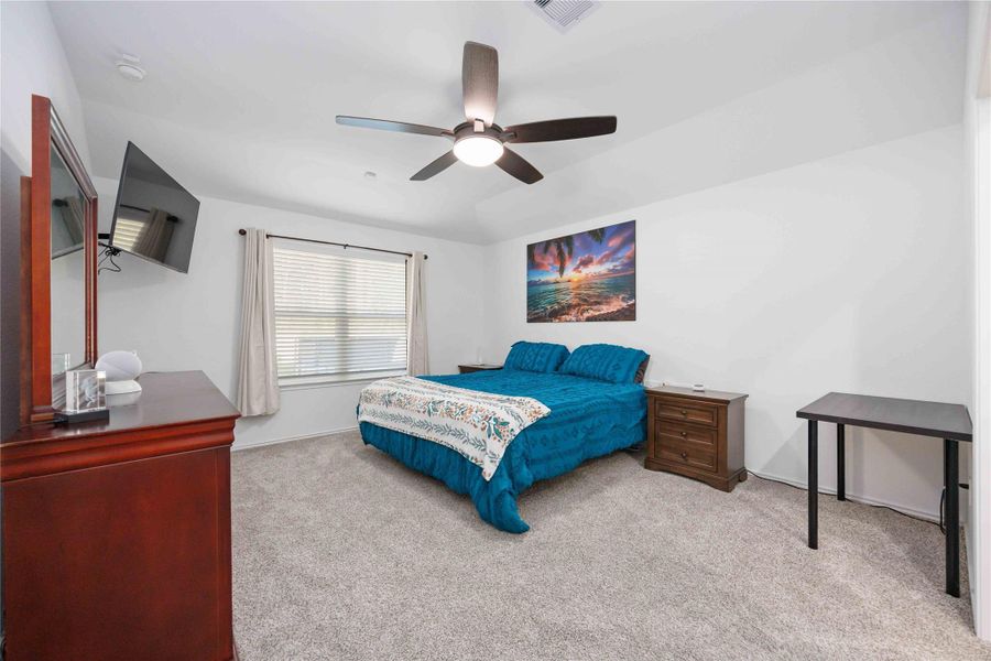 Primary Bedroom:Spacious primary bedroom with plush carpet, ceiling fan, and room for a king-size bed. Primary Bedroom:Spacious primary bedroom with plush carpet, ceiling fan, and room for a king-size bed.