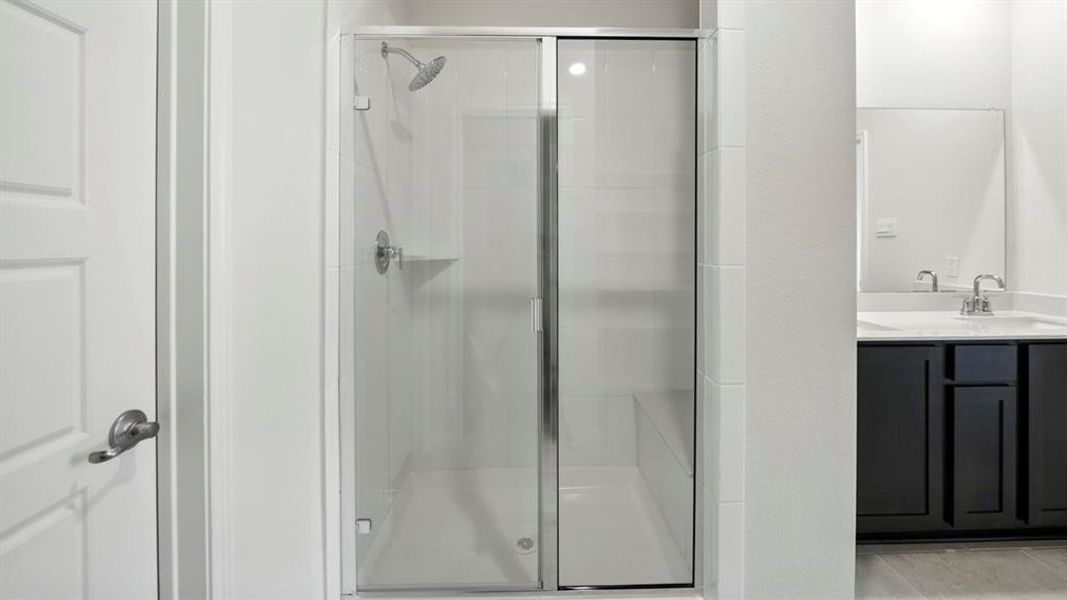 Full bathroom with vanity, a shower stall, and light tile patterned flooring