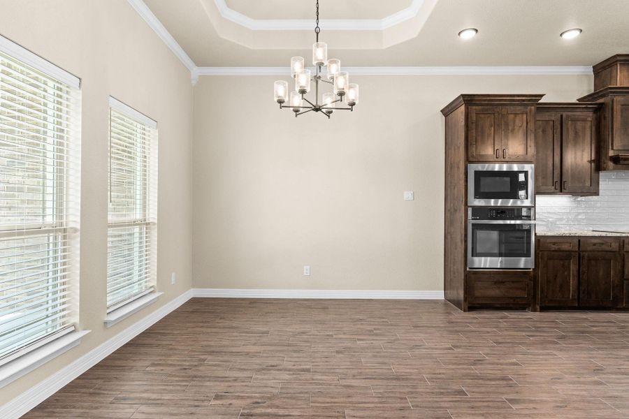 Dining area with crown molding, and chandelier Dining area with crown molding, and chandelier