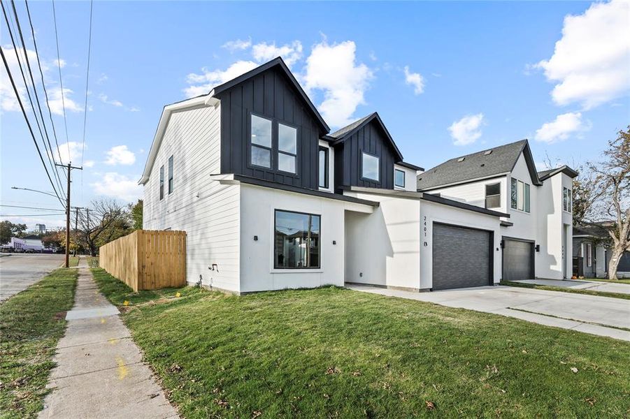 Modern farmhouse style home with driveway, board and batten siding, an attached garage, and stucco siding