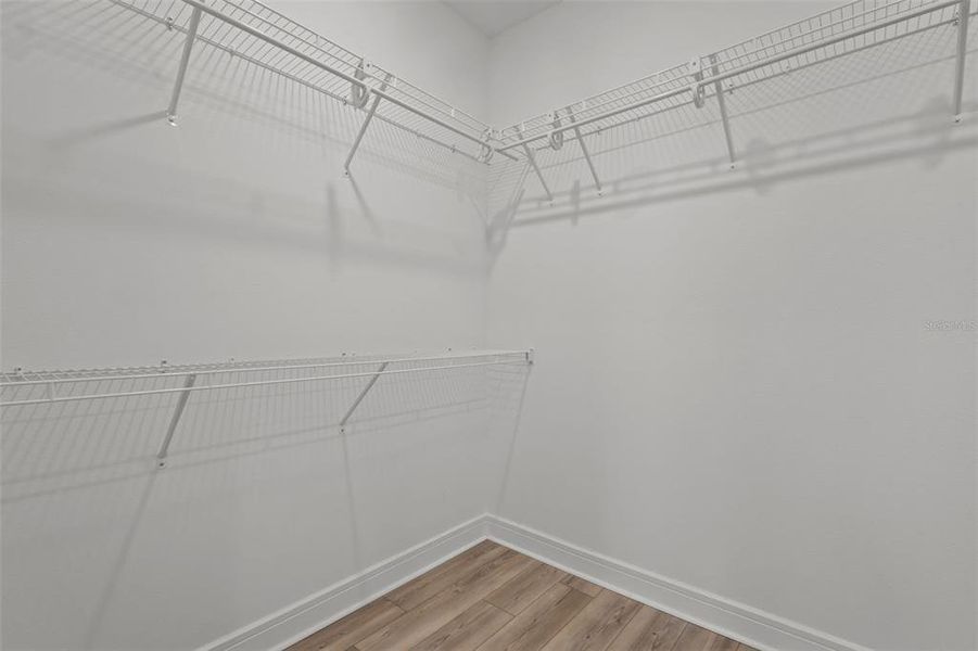 Primary bedroom walk in closet