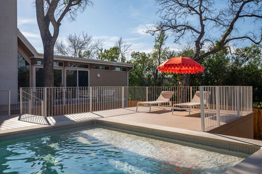 View of swimming pool with a deck