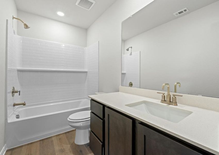 The secondary bathroom of the Piper has a large vanity space and shower-tub combo.