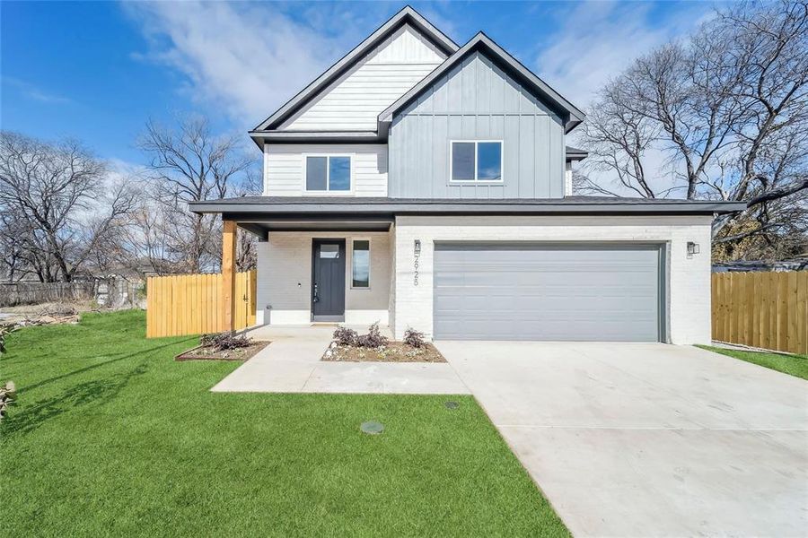 View of front with a garage and a virtually colored front lawn