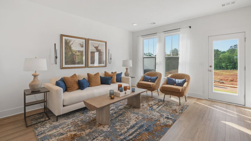 Memorable moments begin in this elegant, open family room with hardwood flooring and refined finishes at Clarke Townes