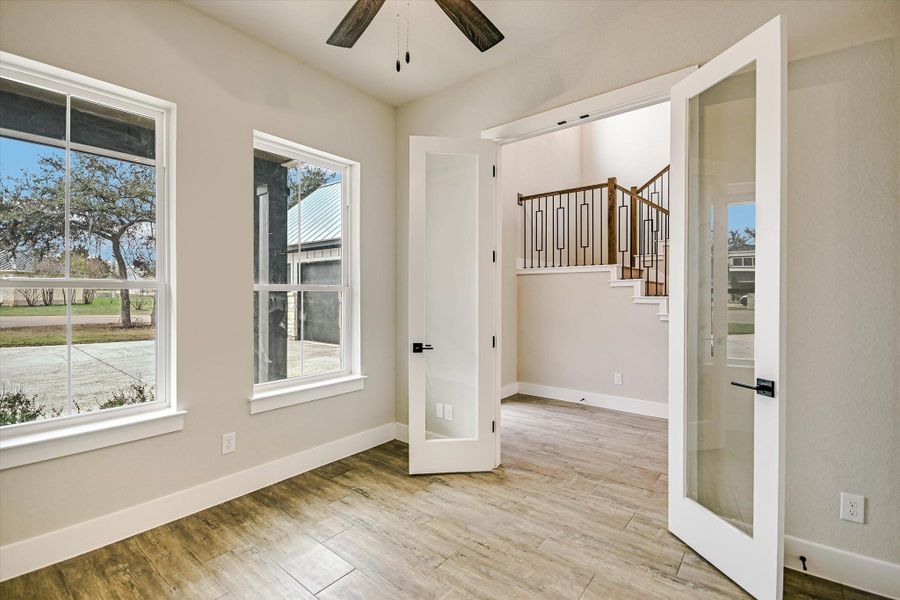 Unfurnished room with a ceiling fan and light wood finished floors