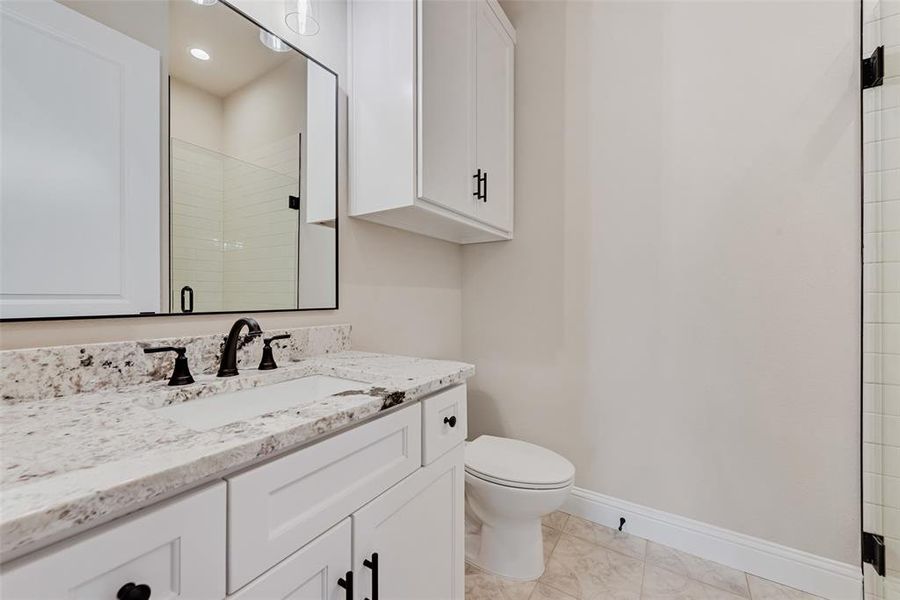 Bathroom featuring vanity and tiled shower