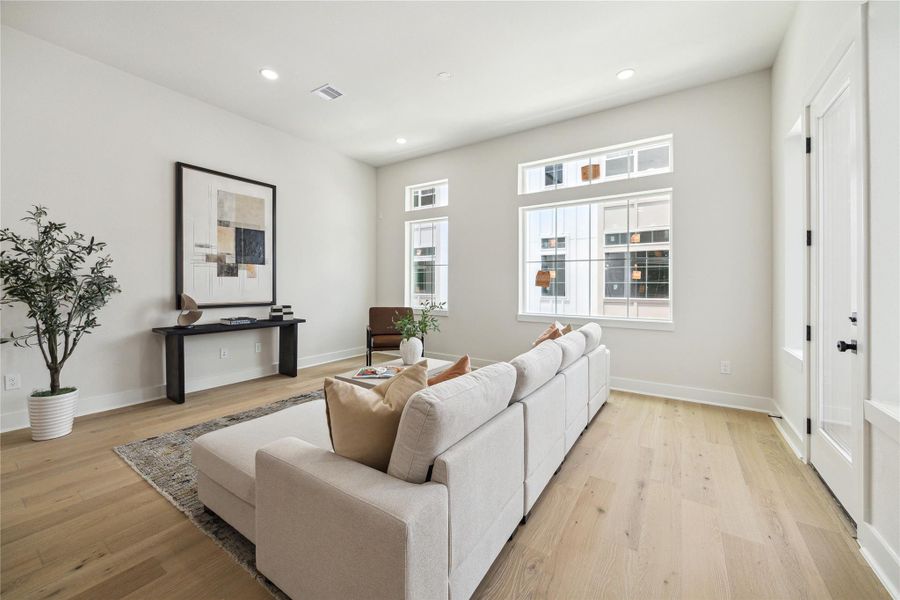 Bright and inviting living room with large windows, modern decor, and beautiful wood floors—perfect for relaxation and entertaining. Bright and inviting living room with large windows, modern decor, and beautiful wood floors—perfect for relaxation and entertaining.
