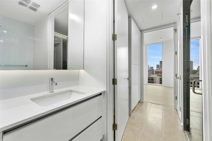 The second bathroom mirrors the elegance of the primary bath, seamlessly incorporating the home's overall aesthetic with matching features and finishes. The second bathroom mirrors the elegance of the primary bath, seamlessly incorporating the home's overall aesthetic with matching features and finishes.