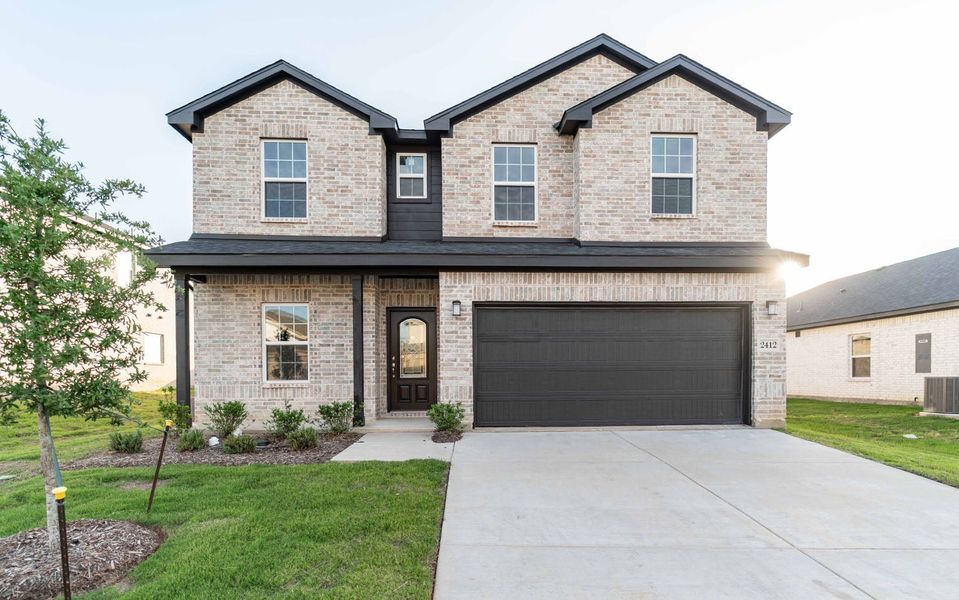 Front exterior of a new home in Pebblebrook, Sherman, TX, highlighting curb appeal (Image 1). Front exterior of a new home in Pebblebrook, Sherman, TX, highlighting curb appeal (Image 1).