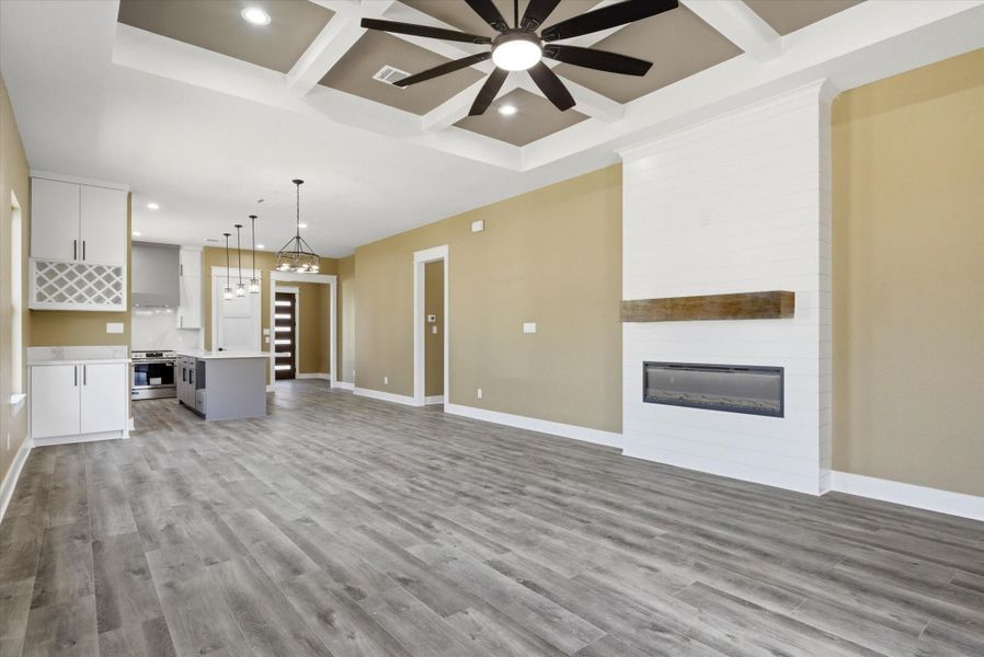 The open-concept living room seamlessly connects to the dining area and kitchen, creating an inviting space ideal for entertaining and everyday living.
